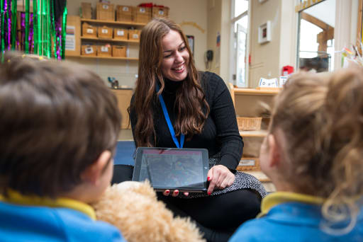 Children and teacher with ipad