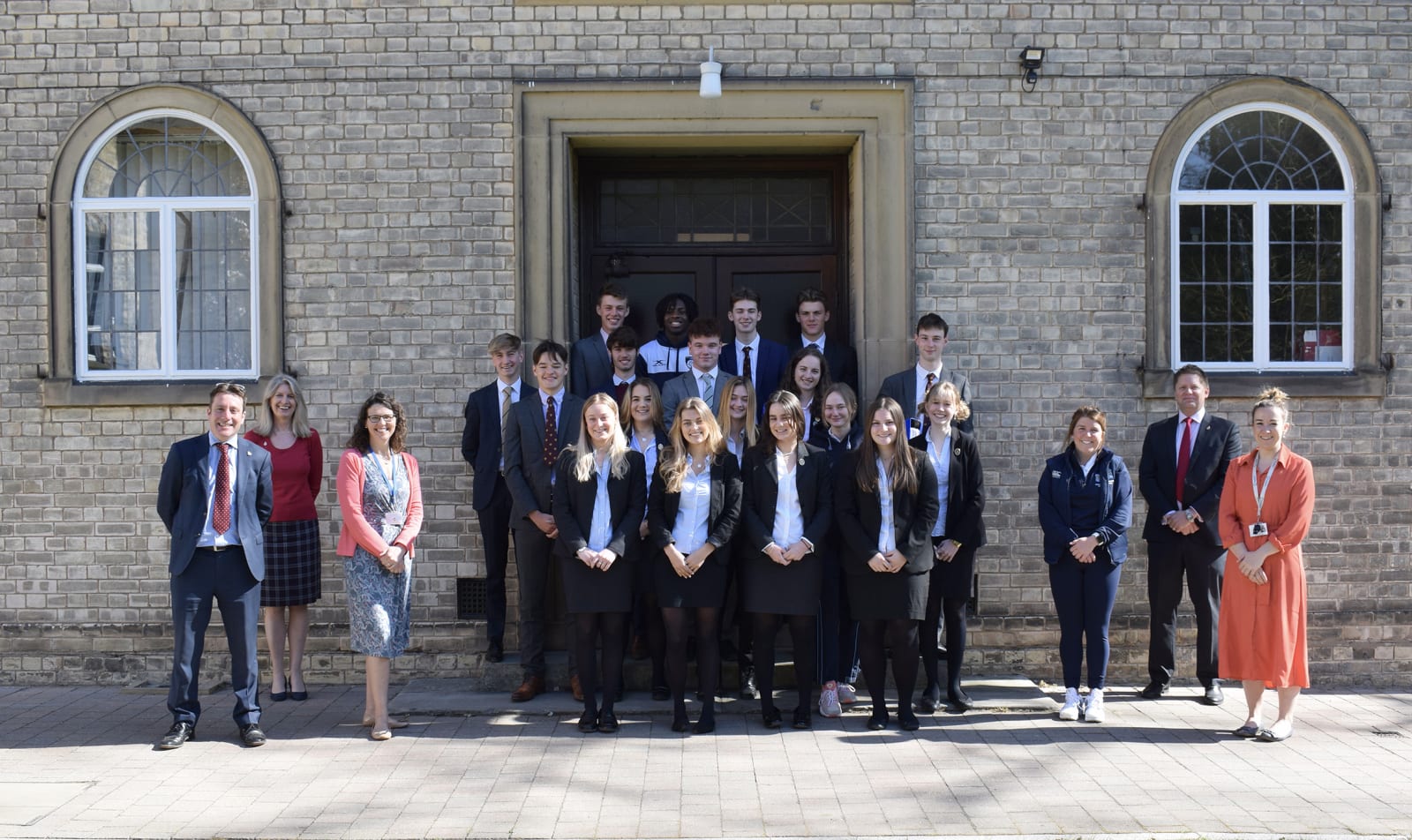 Staff and Sixth Formers outside the music school at Pocklington School