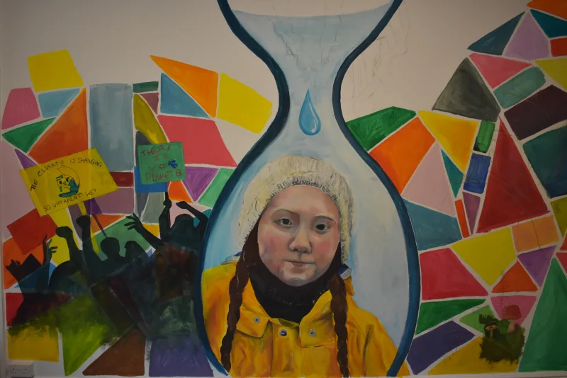 Mural depicting Greta Thunberg under a melting polar ice cap