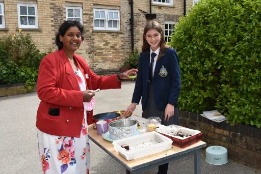 Teacher buying a cake from Charity cake stall at Pocklington School