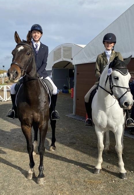 two riders mounted on horse back