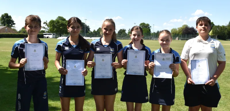 Winning team of 6 First Year pupils holding certificates, stood on the school field