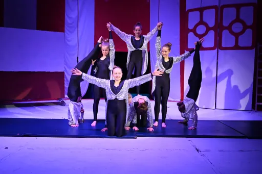 group of gymnasts performing during scene from play Hetty Feather