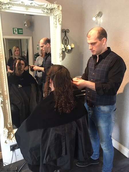 A hair dresser prepares Sean's locks prior to cutting for donation to the Little Princess Trust