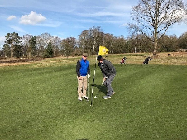 Two Old Pocklingtonians playng the third hole in the Birkdale Bucket Golf Competition at Woodhall Spa Golf Course, Lincolnshire