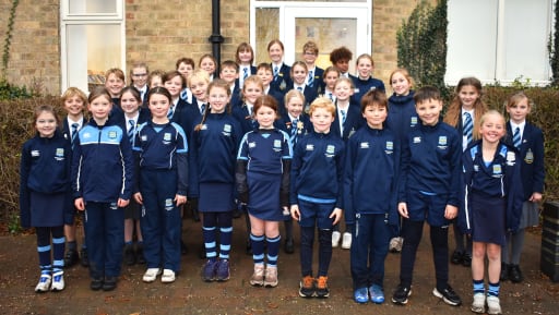 Pocklington Prep School Swim Squad members standing outside the school building in school uniform