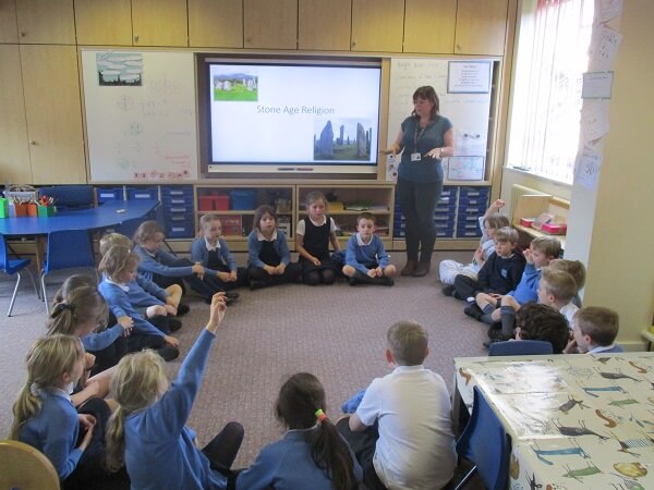 Pocklington School teacher, Mrs Hughes, teaching Year 2 pupils in their classroom,  about the  Mesolithic and Neolithic periods