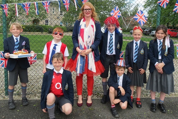 Prep School teacher and pupils display their red, white and blue accessories to celebrate the arrival of the royal baby