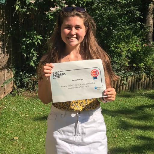 Girl holding bronze award certificate for BTEC awards