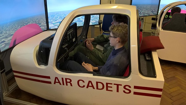 Pocklington School CCF RAF cadet receiving instruction in a flight simulator at RAF Topcliffe