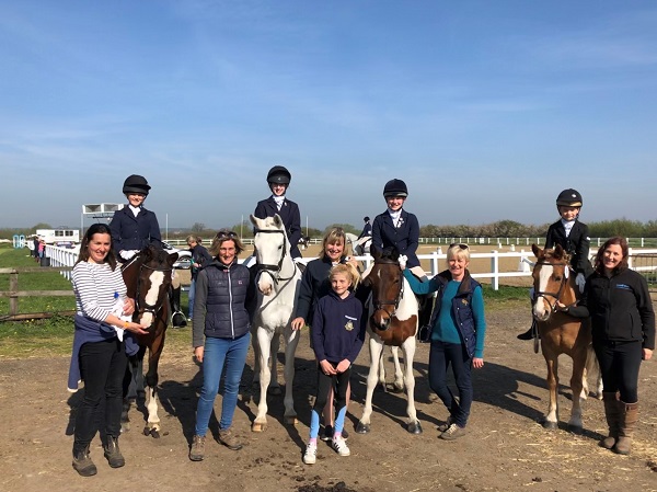 Horses, riders and parents from the Pocklington School Equestrian Team stood in the paddock at the NSEA National County Championships