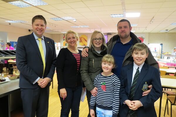 Headmaster, Toby Seth stands in the Pocklington School dining hall, with a FOPS committee member, First Year pupil and their family, during the FOPS Big Breakfast