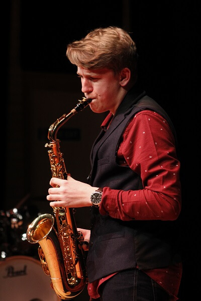 Hutton Pocklington School pupil performing a saxaphone solo during the House Music Festival 2019