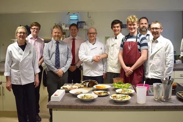 Competitors in the Masterchef-style competition stand with their dish entries in the Pocklington School Cookery Classroom