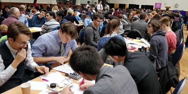 Pocklington School Sixth Form UK Maths Challenge team working out mathematical problems during the national final at the Royal Horticultural Halls, London