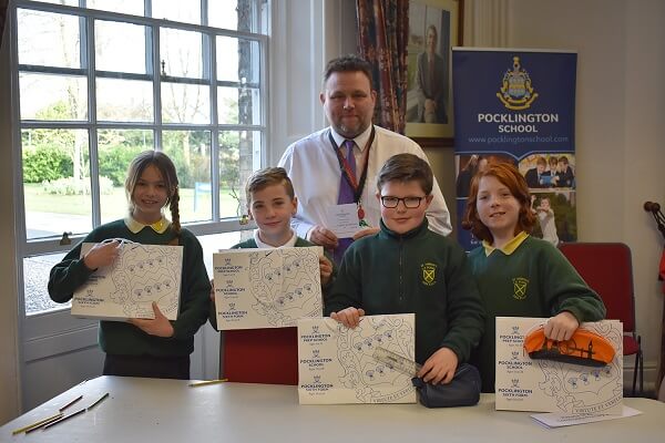 The winning team of four pupils and their teacher from Kirk Ella St Andrew's CP School hold their prizes from the Primary Team Maths Challenge held at Pocklington School