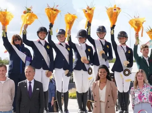 Team GB on the medal podium holding bouguets and medals at the Nations Cup Finals