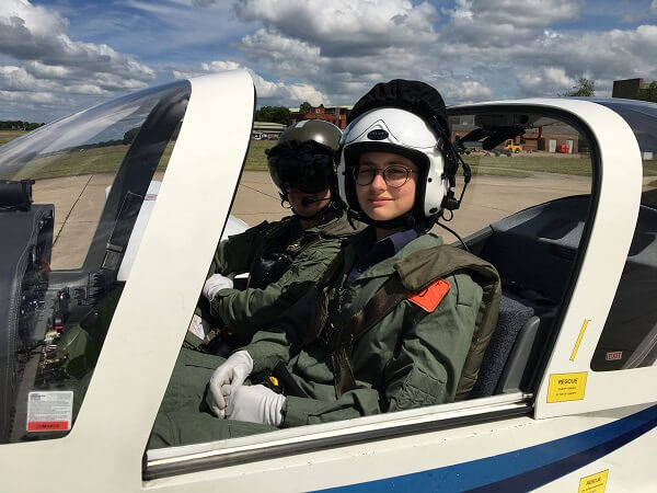 RAF cadet sat in pilot seat inside aeroplane, with instructor from RAF Linton-on-Ouse