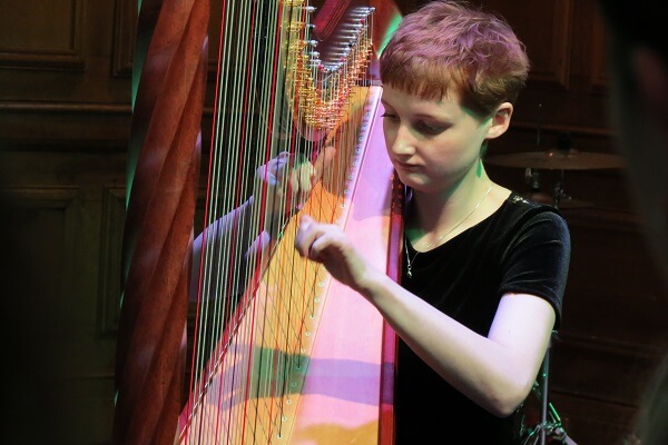 Old Pocklngton playing harp during Charity Concert