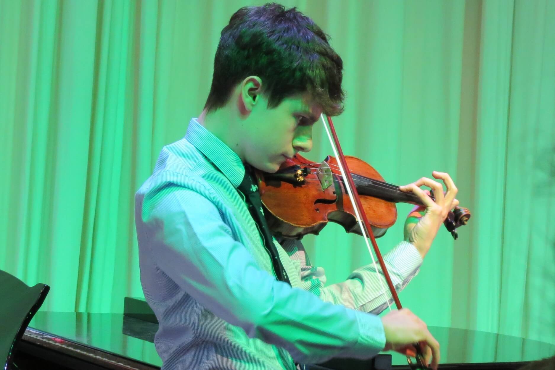 Pocklington School pupil playing violin in charity concert