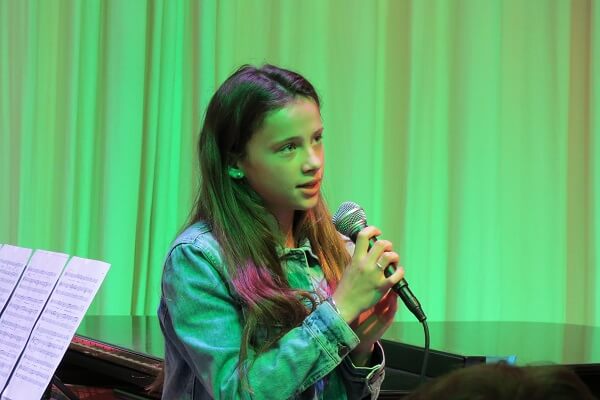 Pocklington School pupil singing a solo in a charity concert