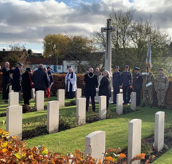 Service personnel and parishioners gather at the Commonwealth War Graves Memorial at St Catherine's Church, Barmby Moor