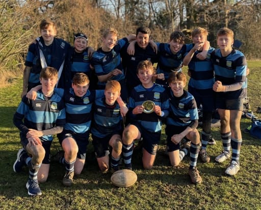 Pocklington School U14 Rugby 7s team photo. One player is holding the Charlton 7s Plate trophy