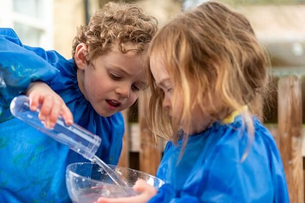 Two Pocklington Prep School pupils play with water in a classroom