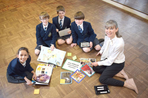 Head of Pocklington Prep and 4 pupils sat working on a floor project