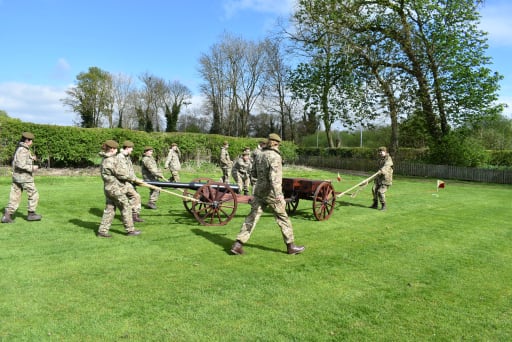 CCF cadets performing the gun run on the school field