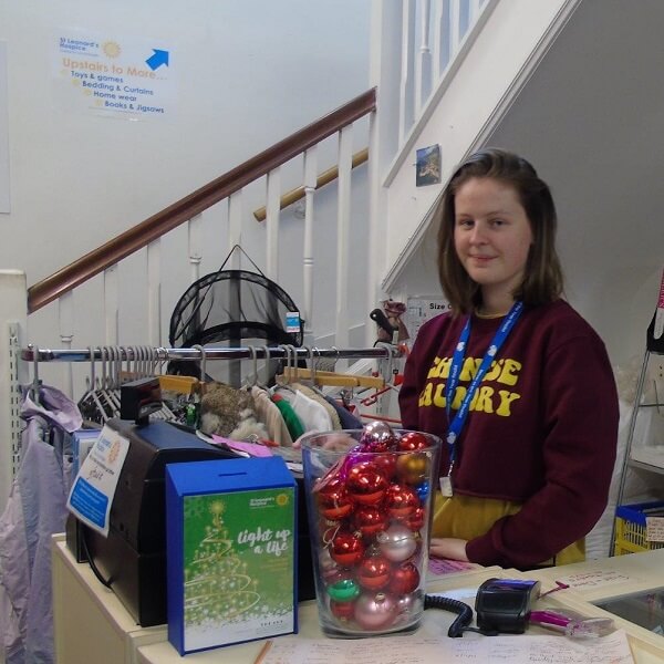 A Sixth Form student volunteering in a local charity shop