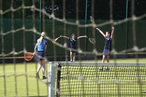 girls at Pocklington School  celebrating a win at tennis on the tennis courts