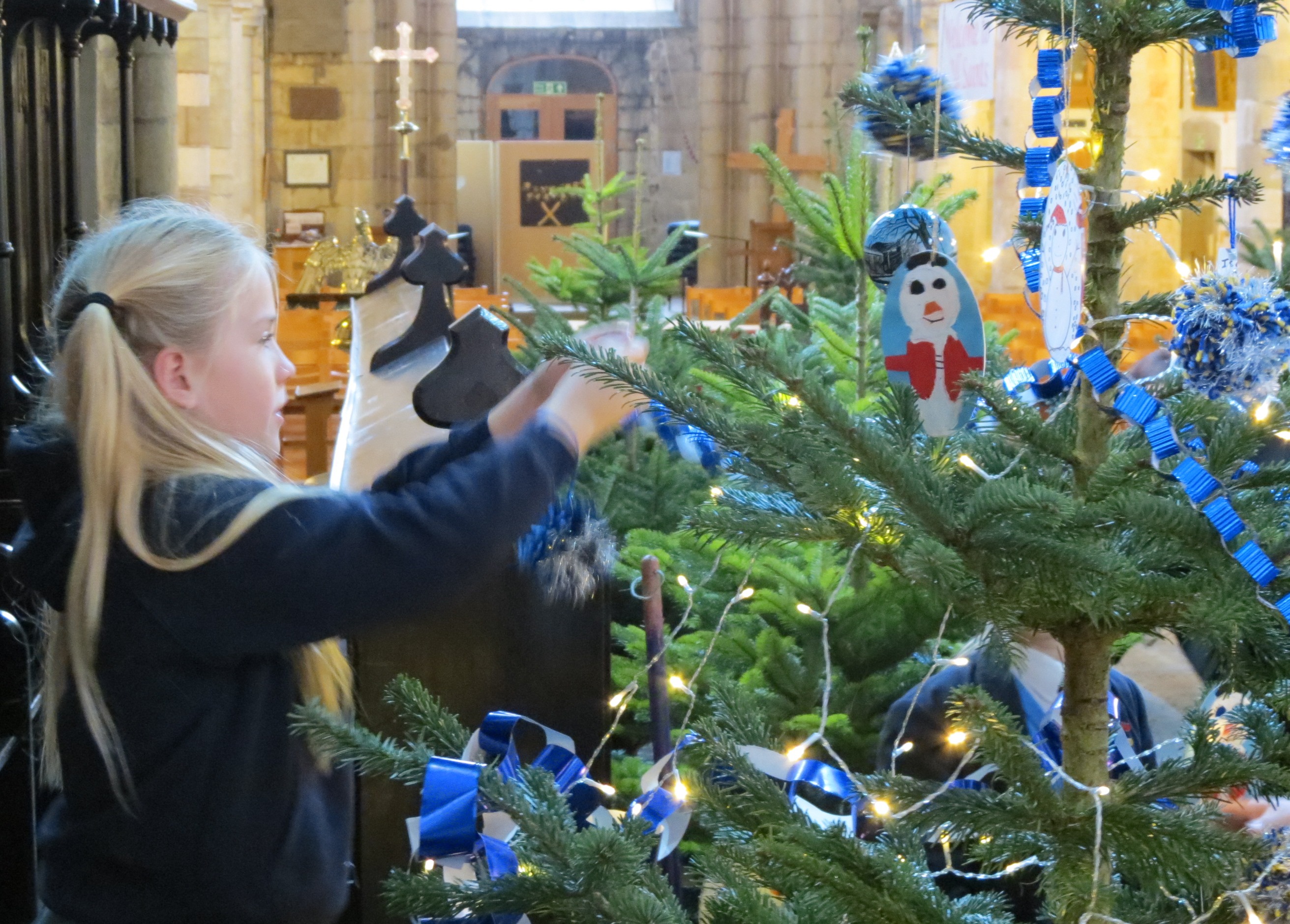 Child decorating Christmas tree