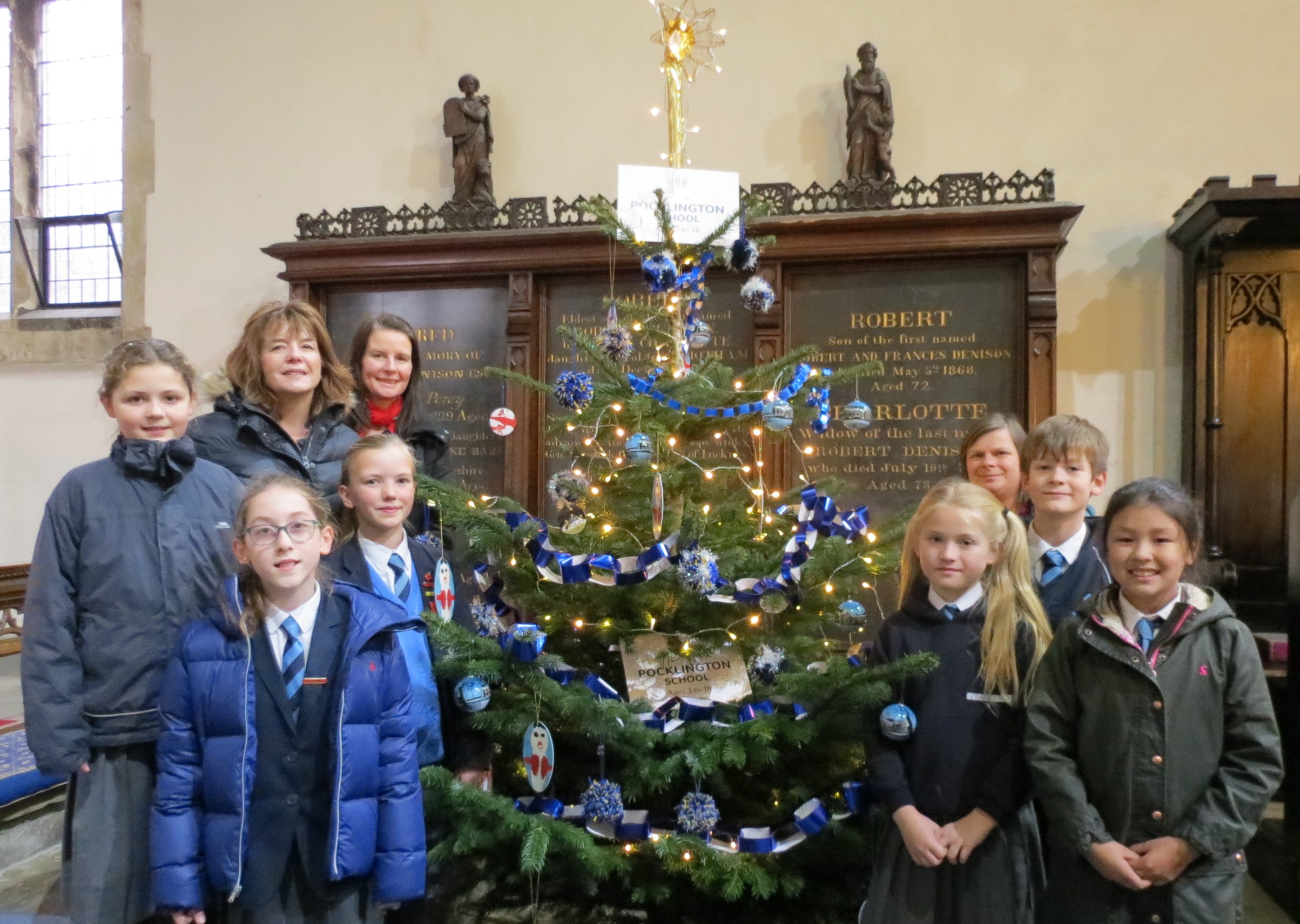 Pupils and staff at All Saint's Church infront of the Pocklington School tree