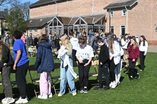 Children playing giant musical chairs on a school field