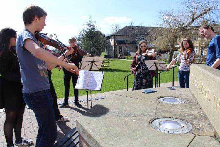 The string section practising outside the Tom Stoppard Theatre