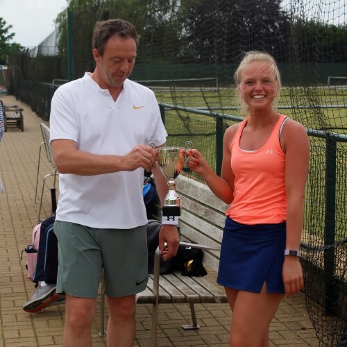 Winners of the Edmund-Loten Insprire mixed doubles tennis tournament hold the winners' trophy.