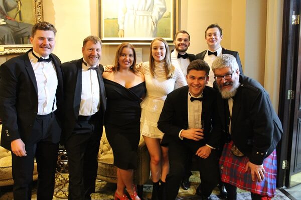 Guests stand in The Churchill Bar at the OP London Black Tie Dinner held at the RAF Club