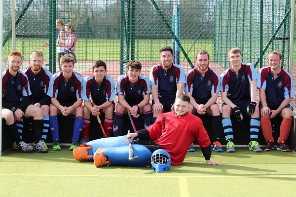 Old Pocklingtonian men's Hockey team sitting in the goal mouth of the hockey pitch