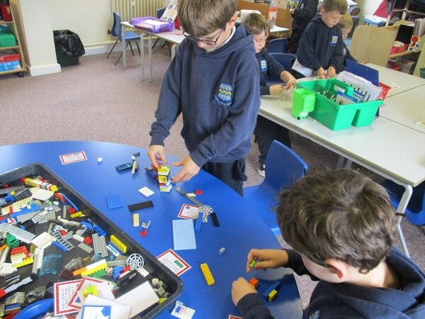 Boys creating 3D images from lego in classroom