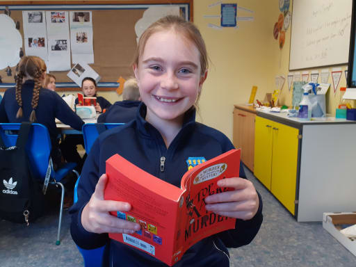 Girl reading a book in Pocklington Prep classroom