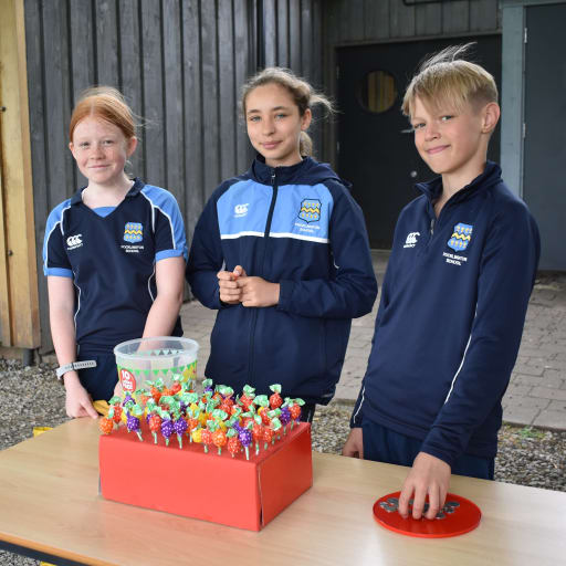 Three pupils holding a charity stall at Pocklington School Charity Week