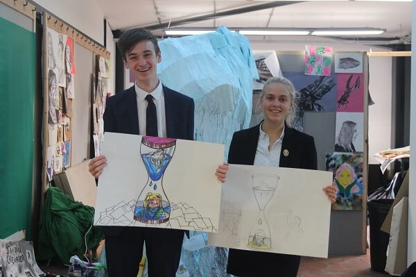 two pupils holding their recreated Greta Thunberg portraits, in the Art and Design Technology Centre at Pocklington School