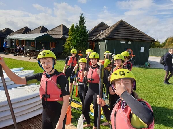 Children dressed in wetsuits prepare to go kayacking at Allerthorpe Lakeland Park