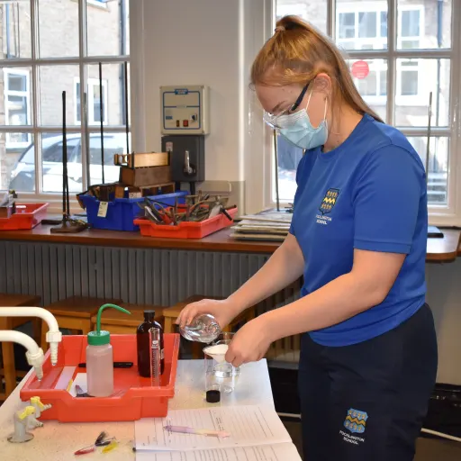 girl carrying out an experiment in a school laboratory