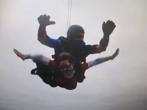 Phoebe and instructor mid free-fall during tandem skydive