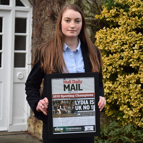 Lydia Robinson at Pocklington School, holding her framed Hull Daily Mail award